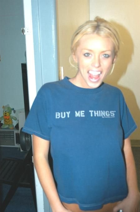 Brittney Skye in a blue T-shirt inside a Los Angeles apartment, grinning at the camera